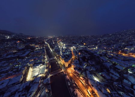 Photo for Sarajevo city hall or national library in town center aerialhyper lapse or time lapse. Landmark in capital of Bosnia and Herzegovina covered with fresh snow in the winter season at night. Hi quality - Royalty Free Image