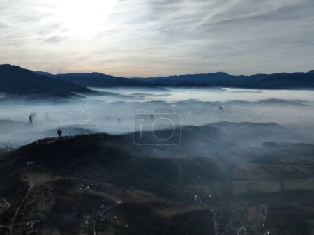Photo for Aerial View. Flying over the high mountains in beautiful clouds. Aerial Drone camera shot. Air pollution clouds over Sarajevo in Bosnia and Herzegovina. Hi quality 4K footage. - Royalty Free Image