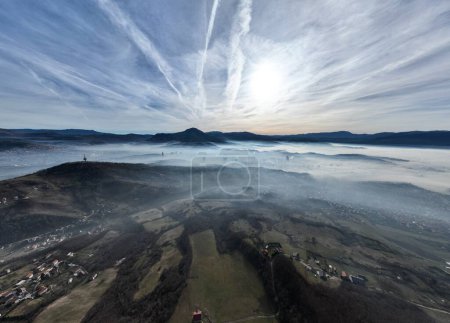 Foto de Aerial View. Flying over the high mountains in beautiful clouds. Aerial Drone camera shot. Air pollution clouds over Sarajevo in Bosnia and Herzegovina. Hi quality 4K footage. - Imagen libre de derechos