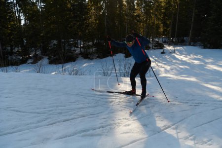 Foto de Nordic skiing or Cross-country skiing classic technique practiced by man in a beautiful panoramic trail at morning. Selective focus - Imagen libre de derechos