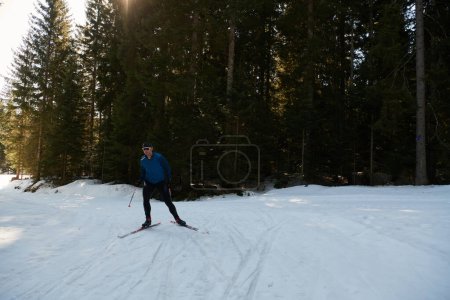 Photo for Nordic skiing or Cross-country skiing classic technique practiced by man in a beautiful panoramic trail at morning. Selective focus - Royalty Free Image