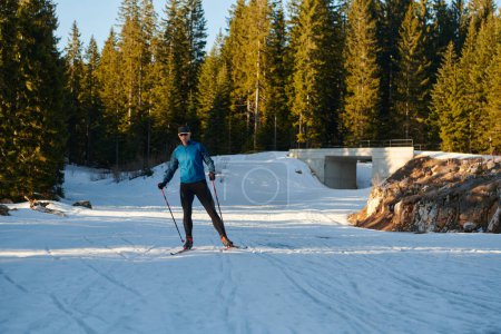 Photo for Nordic skiing or Cross-country skiing classic technique practiced by man in a beautiful panoramic trail at morning. Selective focus - Royalty Free Image