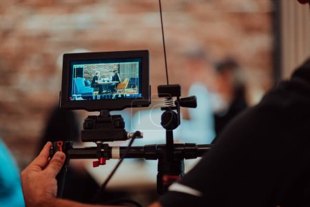 Photo for Behinde The Scenes. A cameraman records a business meeting that is streamed on TV channels. - Royalty Free Image