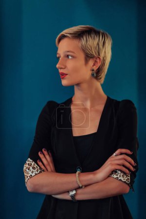 Photo for Blonde business woman, successful confidence with arms crossed on modern blue mat background. Selective focus. - Royalty Free Image