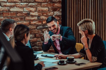 Photo for Happy businesspeople smiling cheerfully during a meeting in a coffee shop. Group of successful business professionals working as a team in a multicultural workplace. - Royalty Free Image