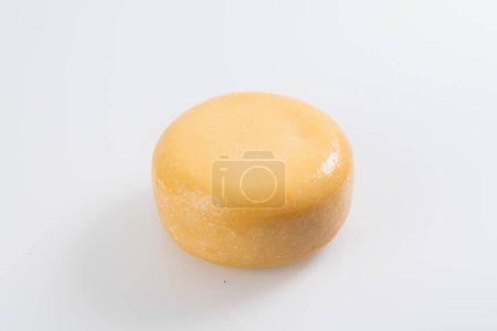 Foto de A piece of fresh processed cheese isolated on a white background. - Imagen libre de derechos