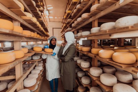 Foto de Arab business partner visiting a cheese factory. The concept of investing in small businesses. - Imagen libre de derechos