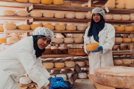 Foto de Muslim business partners check the quality of cheese in the modern industry. - Imagen libre de derechos