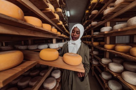 Photo for An Arab investor in a warehouse of the cheese production industry. - Royalty Free Image