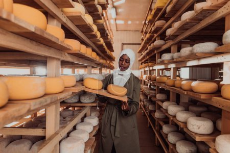 Foto de An Arab investor in a warehouse of the cheese production industry. - Imagen libre de derechos