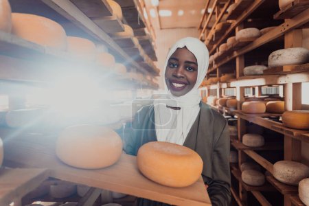 Foto de An Arab investor in a warehouse of the cheese production industry. - Imagen libre de derechos