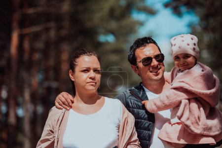 Photo for Family fun in the park. Happy family spending time in park and playing with their daughter. - Royalty Free Image