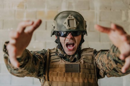 Photo for Success in the war campaign. A soldier with raised hands celebrates the successful conquest of enemy territory. - Royalty Free Image