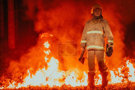 Photo for Firefighter at job. Firefighter in dangerous forest areas surrounded by strong fire. Concept of the work of the fire service. - Royalty Free Image