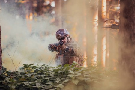 Photo for A modern warfare soldier on war duty in dense and dangerous forest areas. Dangerous military rescue operations. - Royalty Free Image