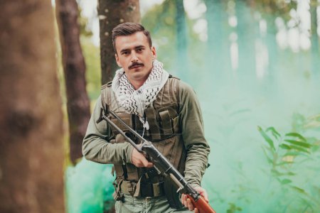Photo for Angry terrorist militant guerrilla soldier warrior in forest. - Royalty Free Image