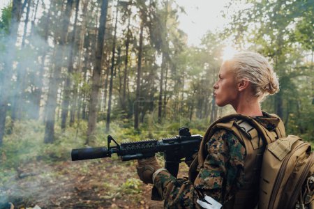 Téléchargez les photos : Femme soldat prête pour la bataille portant un équipement militaire de protection et une arme. - en image libre de droit