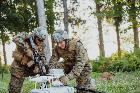 Photo for Modern Warfare Soldiers Squad are Using Drone for Scouting and Surveillance During Military Operation in the Forest. - Royalty Free Image