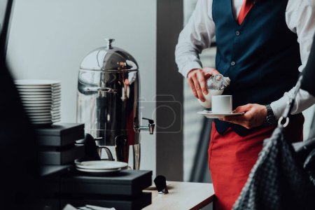 Photo for The waiter preparing coffee for hotel guests. Close up photo of service in modern hotels. - Royalty Free Image
