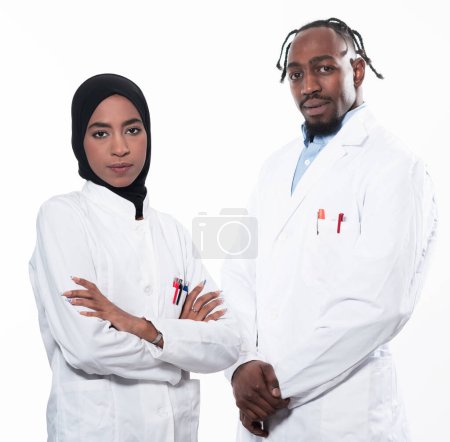 Photo for Closeup front view of group of mixed age doctors and nurses standing side by side and looking at the camera. Young Middle Eastern female in a team with African American black doctor. High quality - Royalty Free Image