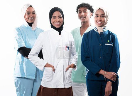 Photo for Closeup front view of group of mixed age doctors and nurses standing side by side and looking at the camera. Young Middle Eastern female in a team with African American black doctor. High quality - Royalty Free Image