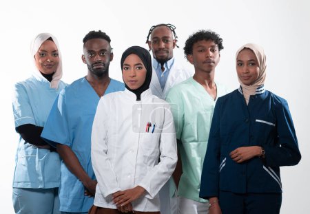 Photo for Team or group of a doctor, nurse and medical professional coworkers standing together. Portrait of diverse healthcare workers looking confident. Middle Eastern and African, Muslim medical team. High - Royalty Free Image