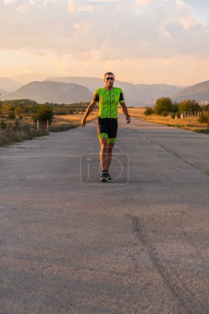 Foto de Triatleta en equipo profesional corriendo temprano en la mañana, preparándose para una maratón, dedicación al deporte y disposición para asumir los desafíos de una maratón - Imagen libre de derechos