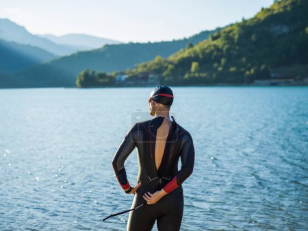 Photo for A triathlon swimmer preparing for a river training to gear up for a marathon. High quality photo - Royalty Free Image