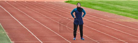 Photo for A muslim woman in a burqa sports muslim clothes running on a marathon course and preparing for upcoming competitions. - Royalty Free Image