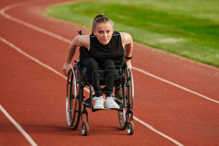 Photo for A woman with disablity driving a wheelchair on a track while preparing for the Paralympic Games. - Royalty Free Image