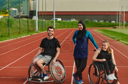 Téléchargez les photos : Une femme handicapée en fauteuil roulant qui parle après s'être entraînée avec une femme portant un hijab et un homme en fauteuil roulant. - en image libre de droit