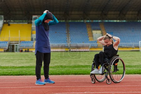 Photo for Two strong and inspiring women, one Muslim in a burka and the other in a wheelchair stretching necks while on the marathon course. - Royalty Free Image