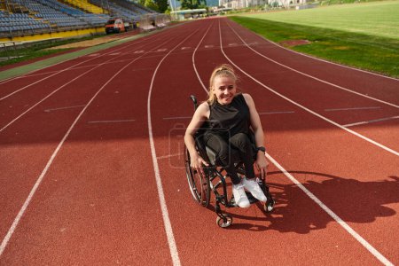 Photo for A woman with disablity driving a wheelchair on a track while preparing for the Paralympic Games. - Royalty Free Image