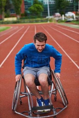 Photo for A person with disability in a wheelchair training tirelessly on the track in preparation for the Paralympic Games - Royalty Free Image