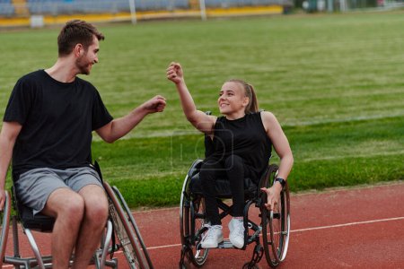 A woman with disability in a wheelchair talking with friend after training on the marathon course. 