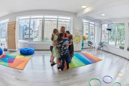 Photo for A child hugging a teacher in a modern kindergarten. High quality photo - Royalty Free Image