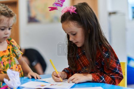 Photo for Creative kids sitting in a preschool institution, draw and have fun while they get an education. High quality photo - Royalty Free Image