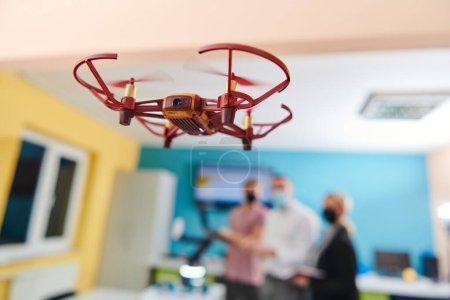 Photo for A group of students working together in a laboratory, dedicated to exploring the aerodynamic capabilities of a drone. - Royalty Free Image