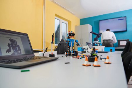 Photo for A student testing his new invention of a robotic arm in the laboratory, showcasing the culmination of his research and technological prowess - Royalty Free Image