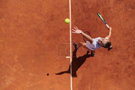 Foto de Vista superior de una jugadora de tenis profesional sirve la pelota de tenis en la cancha con precisión y poder. - Imagen libre de derechos