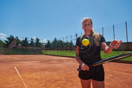 Photo for Before her training, the tennis player joyfully playing with a tennis ball, radiating enthusiasm and playfulness, as she prepares herself mentally and physically for the upcoming challenges on the - Royalty Free Image