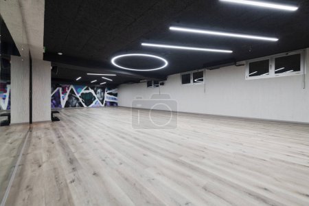 Photo for An empty dance hall with a glass wall adorned with decorative graffiti, offering a fusion of contemporary, urban artistic ambiance and impressive aesthetics - Royalty Free Image
