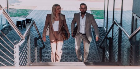 Photo for Modern business couple after a long days work, walking together towards the comfort of their home, embodying the perfect blend of professional success and personal contentment - Royalty Free Image