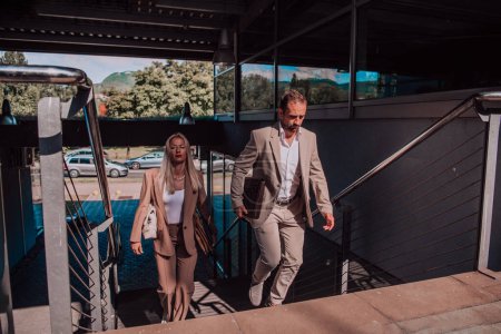 Photo for Modern business couple after a long days work, walking together towards the comfort of their home, embodying the perfect blend of professional success and personal contentment - Royalty Free Image