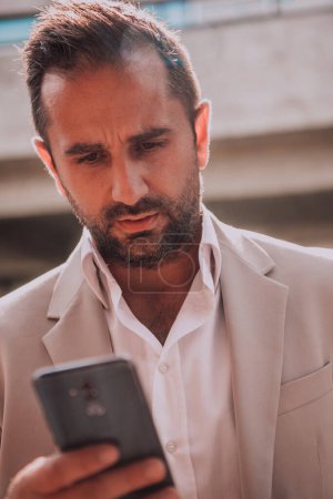 Photo for A businessman using his smartphone outdoors, showcasing the seamless integration of technology and mobility in modern professional life - Royalty Free Image