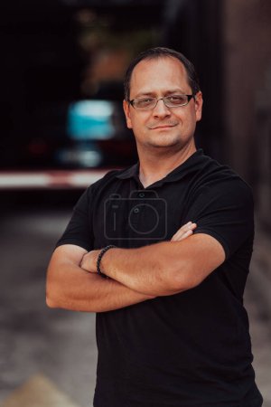 Photo for A successful businessman with crossed arms, posing outdoors. High quality photo - Royalty Free Image