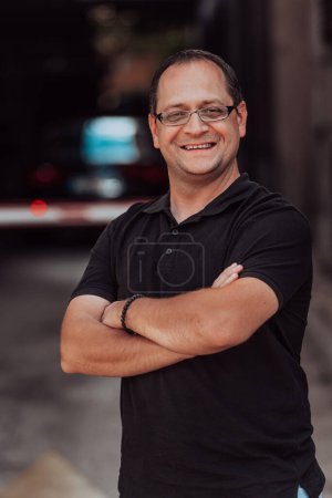 Photo for A successful businessman with crossed arms, posing outdoors. High quality photo - Royalty Free Image