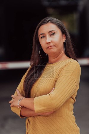 Photo for A powerful portrait of a businesswoman, standing confidently with her arms crossed, representing the determination of the female gender and embodying strength and success. - Royalty Free Image