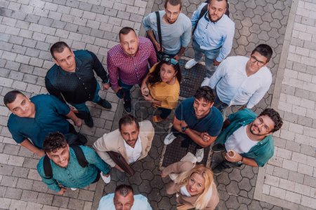 Photo for A top view photo of group of businessmen and colleagues standing together, looking towards the camera, symbolizing unity and teamwork - Royalty Free Image