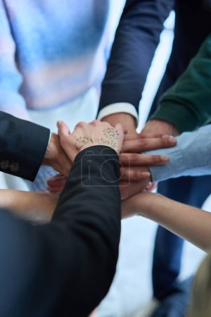 Photo for A top view photo of group of businessmen holding hands together to symbolize unity and strength. High quality photo - Royalty Free Image